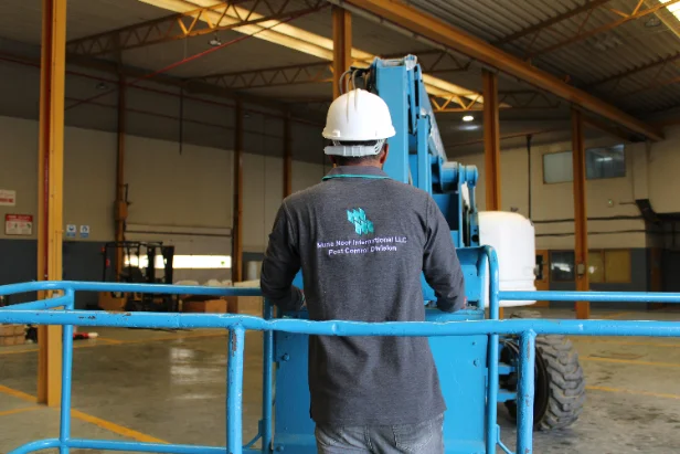 A Muna Noor technician in a hard hat on a bird control job
